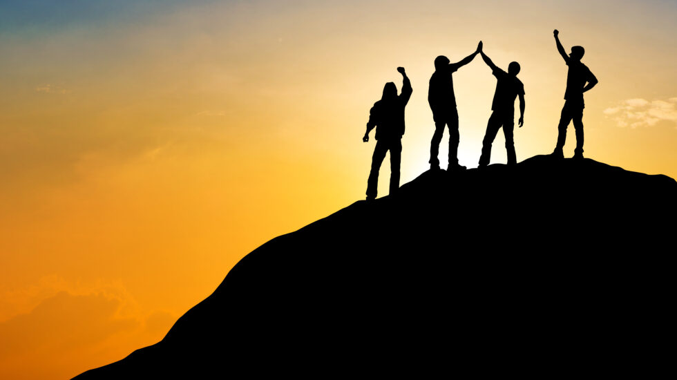 Group of people on peak mountain with sunset background ,team work success business winner concept